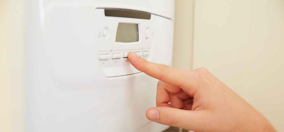 Woman checking boiler