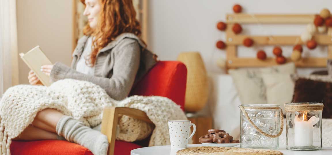 Woman on chair with blanket