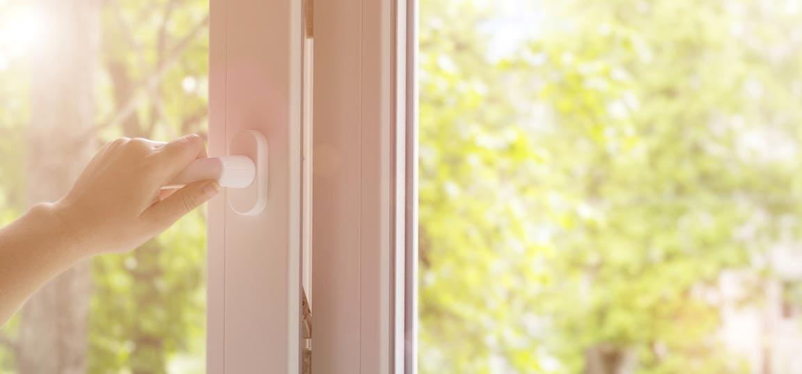 Person opening window to encourage the air to flow and help the room to cool down fast.