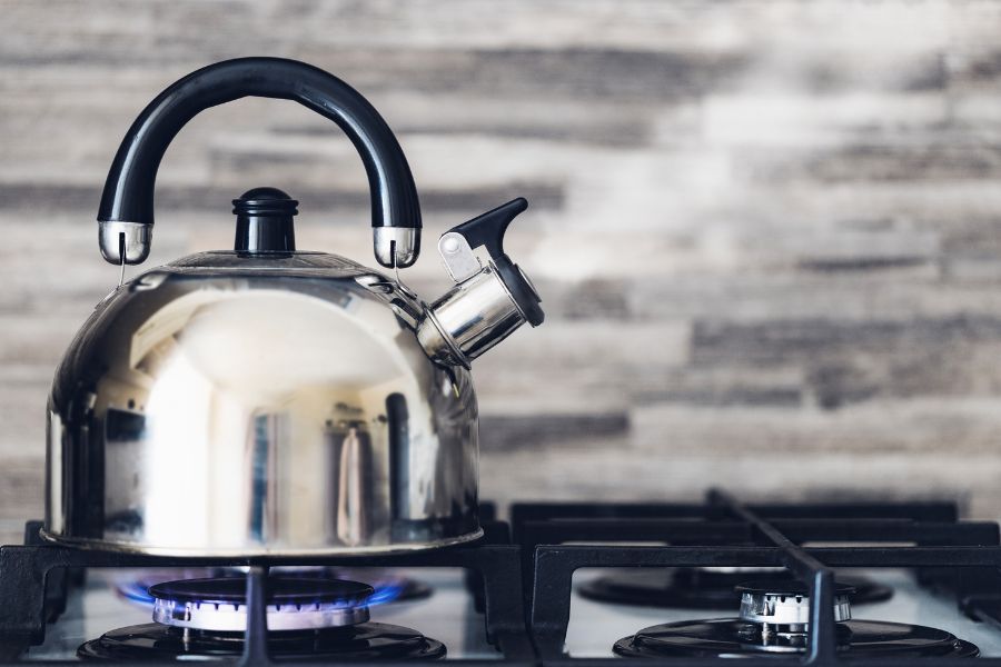 Water boiling in a stove kettle which is cheaper but more time consuming than electric