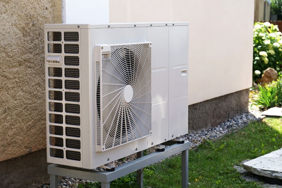 An air source heat pump mounted outside of the home